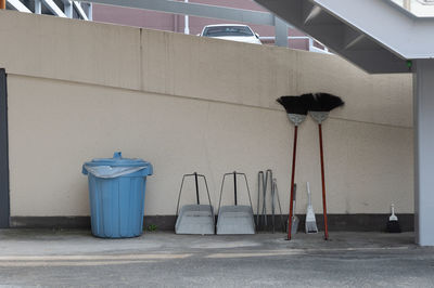 Garbage bin against wall in city