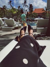 Low section of woman lying down in swimming pool