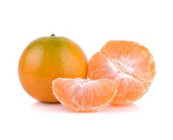 Close-up of orange slice against white background