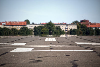 Road sign against sky in city