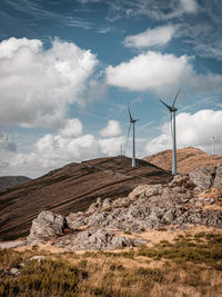 Windmill on field against sky