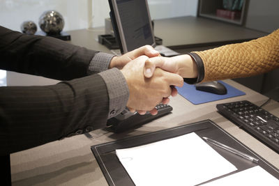 Midsection of man using laptop on table