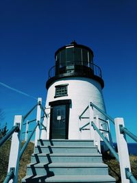 Low angle view of lighthouse against clear blue sky