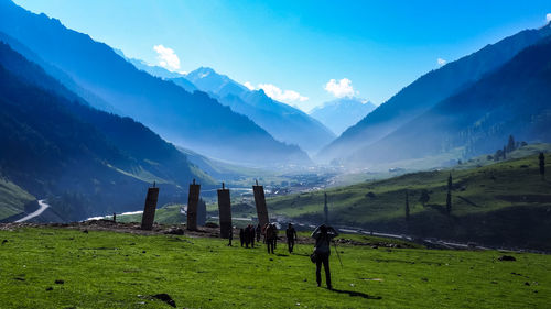 Scenic view of field and mountains against sky