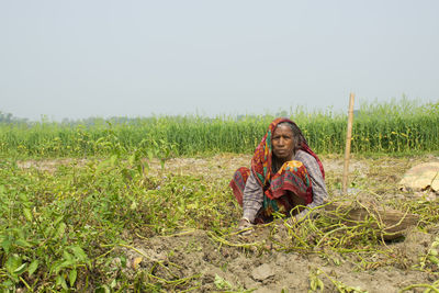 Portrait of woman working  at farm land