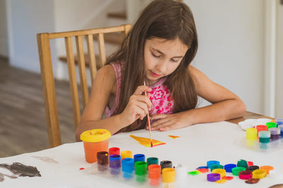 Girl looking away on table at home