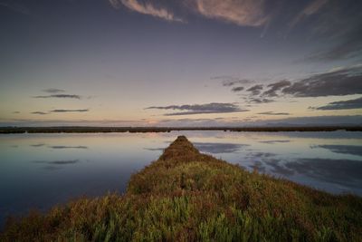 Scenic view of lake against sky during sunset