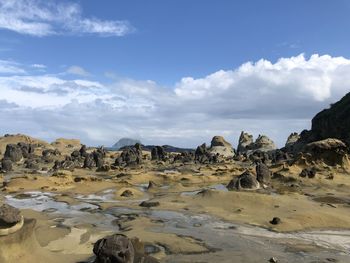 Rock formations on landscape against sky