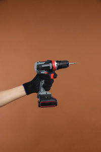 Close-up of coin-operated binoculars against orange background