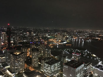 High angle view of illuminated buildings in city at night