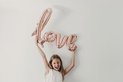 Portrait of a smiling girl against white background