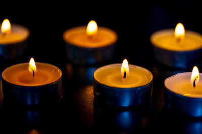 Close-up of lit candles in temple