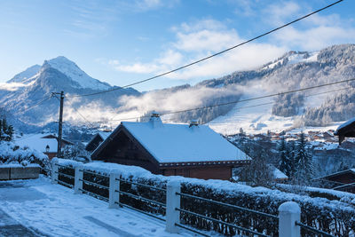 Houses against snowcapped mountains