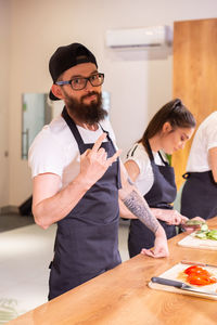 Portrait of smiling friends working on table