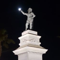 Low angle view of statue of lit up at night