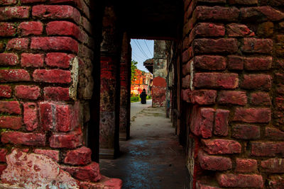 Rear view of man standing in old building