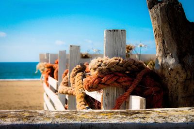 Close-up of rope tied on fence at beach