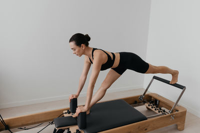 Young woman exercising in gym