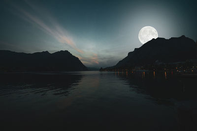 Scenic view of lake against sky at night