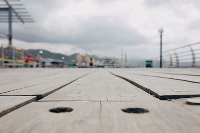 Surface level of boardwalk against sky