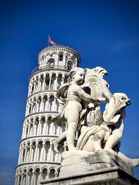 Low angle view of statue against blue sky