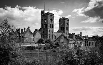 Low angle view of historic building against cloudy sky