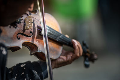 Midsection of man playing violin