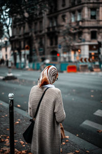 Rear view of woman standing on street