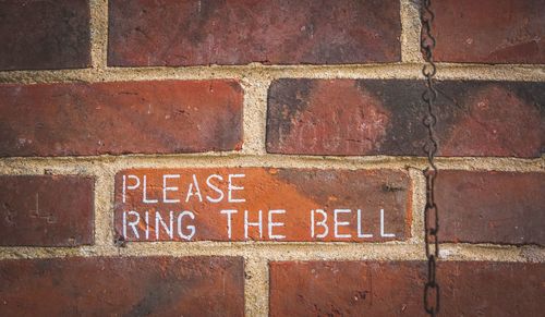 Close-up of text on brick wall