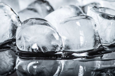 Ice cubes on a black reflective background