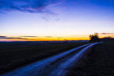 Scenic view of road against sky during sunset