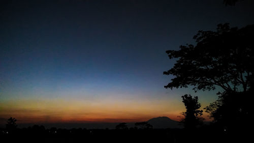 Scenic view of silhouette landscape against sky at sunset