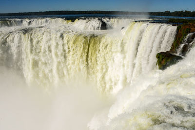 Scenic view of waterfall in sea