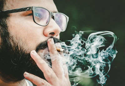 Portrait of man smoking cigarette