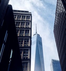 Low angle view of modern building against cloudy sky