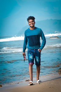 Rear view of man standing at beach