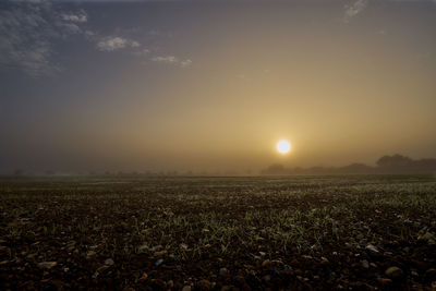 Scenic view of field against sky during sunset