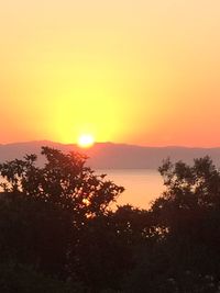 Scenic view of sea against orange sky