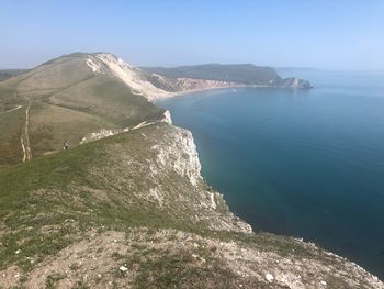 High angle view of sea and mountains against clear sky