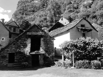 Exterior of old house amidst trees and buildings
