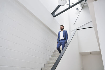 Low angle view of man standing on staircase