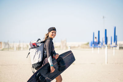 Portrait of young woman standing on beach