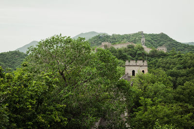 Great wall of china by trees against sky