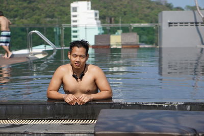 Portrait of shirtless man in swimming pool