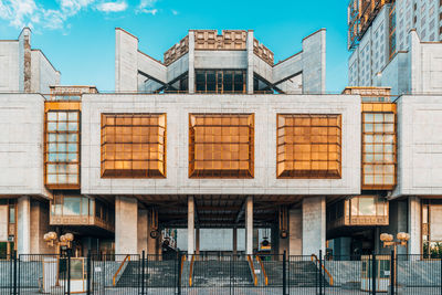 Low angle view of modern building against blue sky