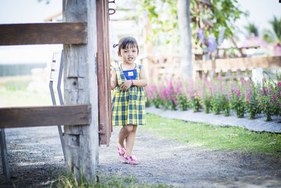 Full length of smiling boy standing in park