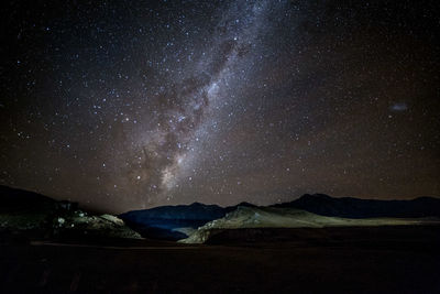 Scenic view of mountains against sky at night