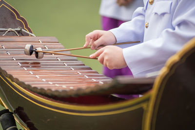 Midsection of man playing piano at music concert