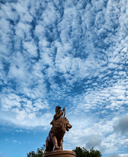 Low angle view of horse statue against sky