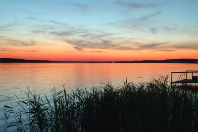Scenic view of sea against romantic sky at sunset